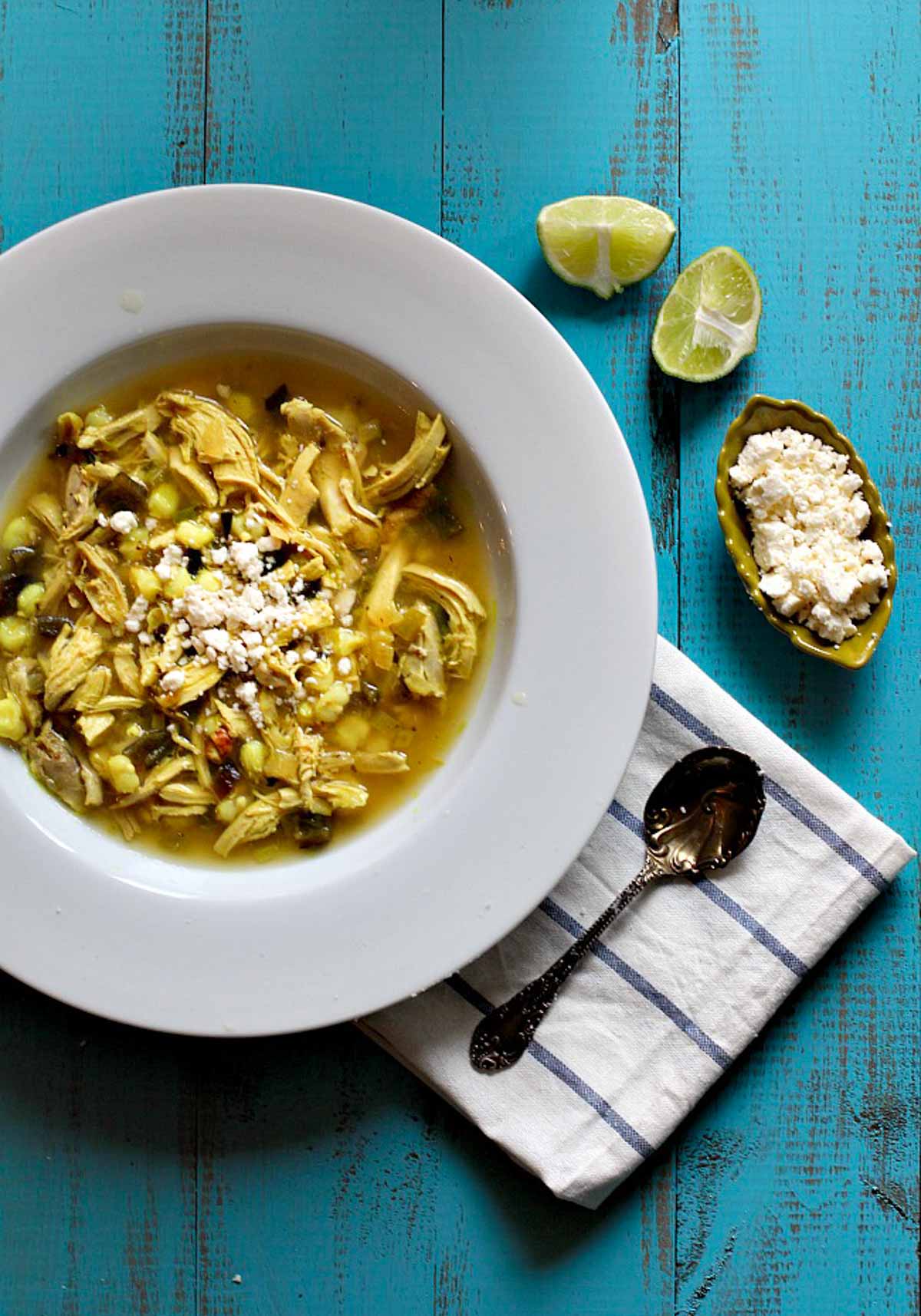 Chicken poblano soup with hominy and limes