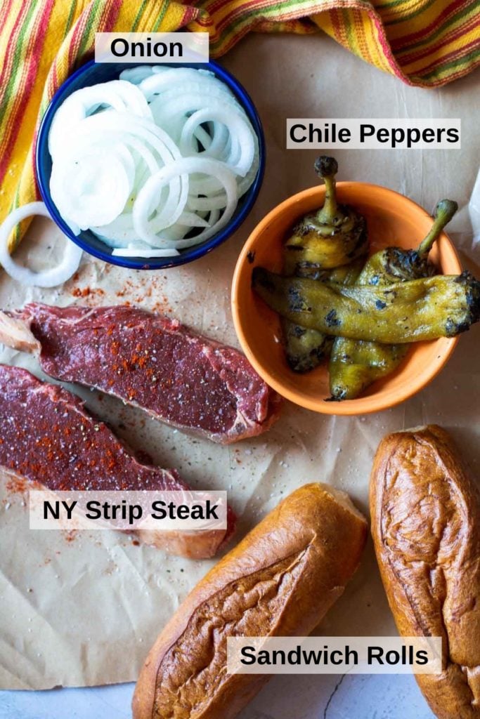 Ingredients to make a steak and cheese sandwich.