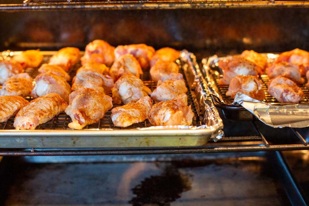 Baking chicken wings on sheet pans.