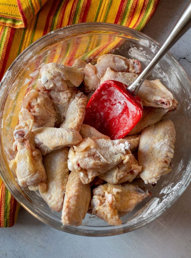Mixing baking powder into chicken wings for crispy baked wings.