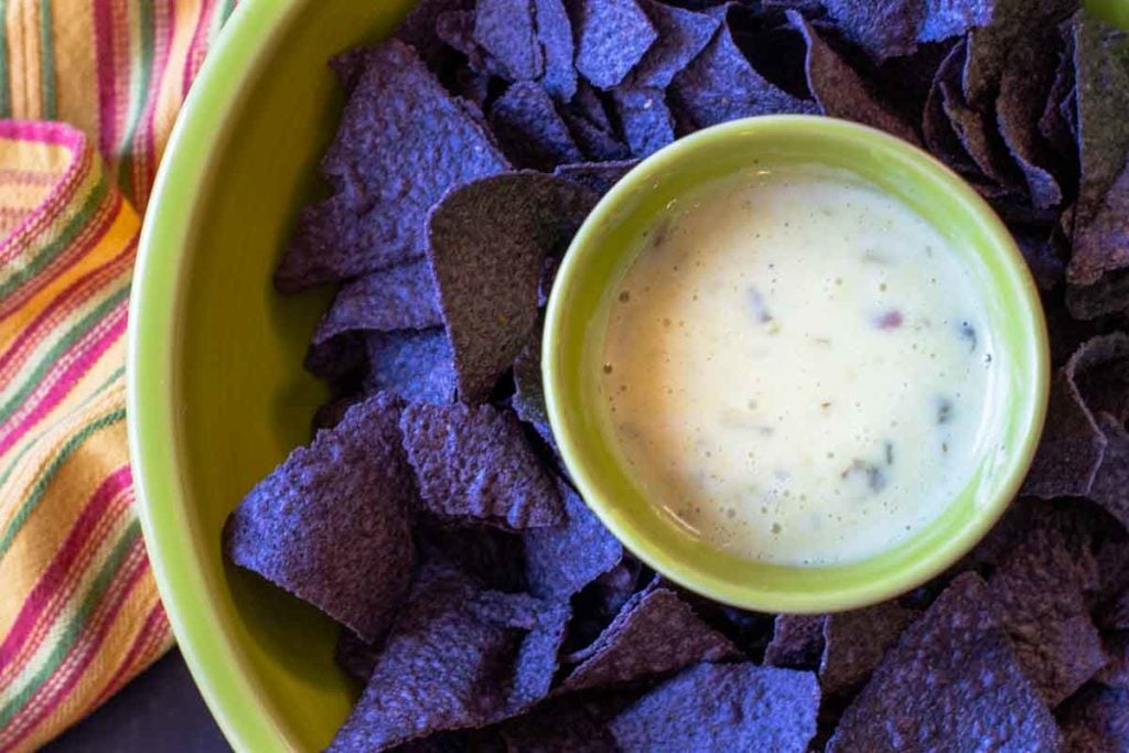 Queso blanco cheese dip served with blue corn tortilla chips
