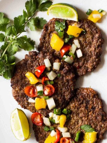 Mexican Pacholas, Mexican meat patties topped with salsa.