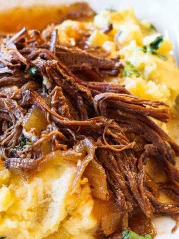 Crock pot coca cola brisket, shredded and served over mashed potatoes.