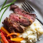 Pan seared bison steak served over mashed potatoes.