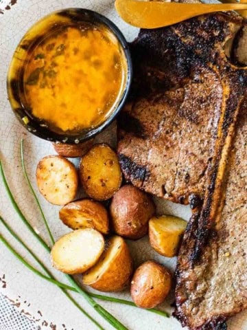 Grilled t-bone steaks served with cowboy butter.