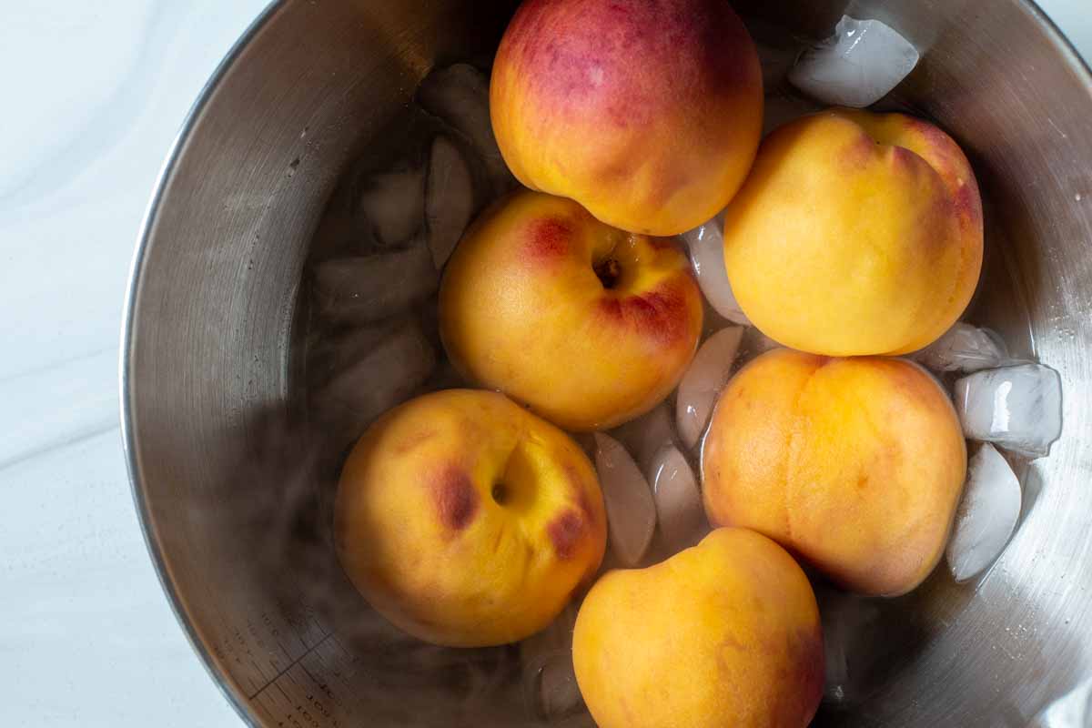 Boiled peaches in an ice bath for easy peeling.
