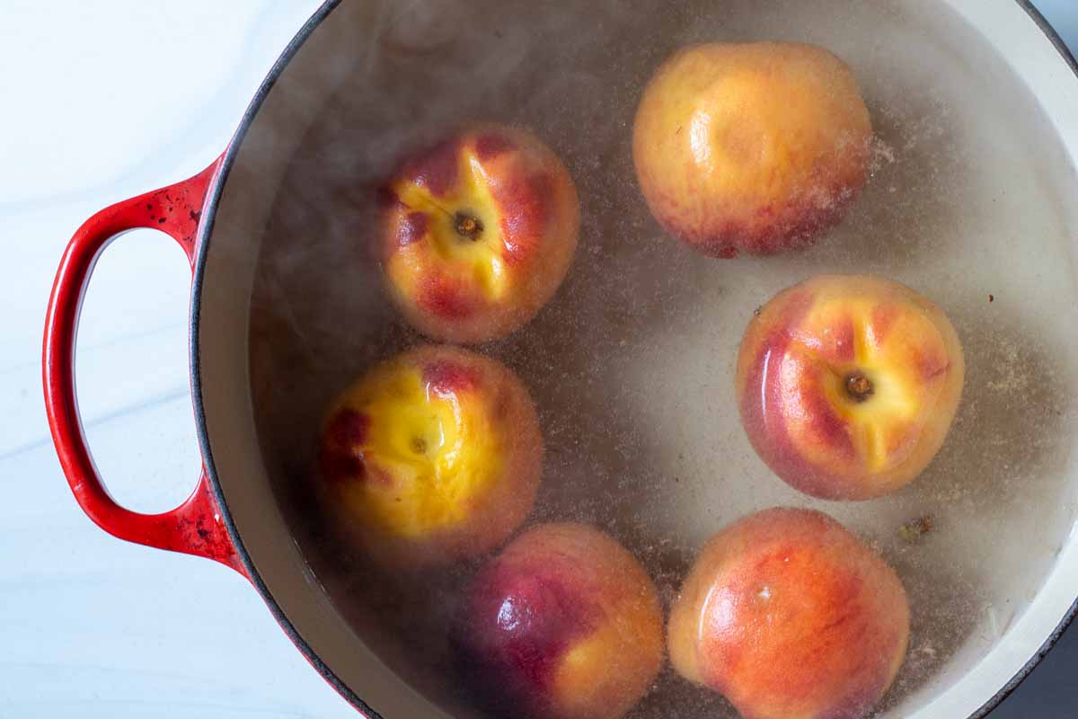 Simmering peaches for easy peeling.