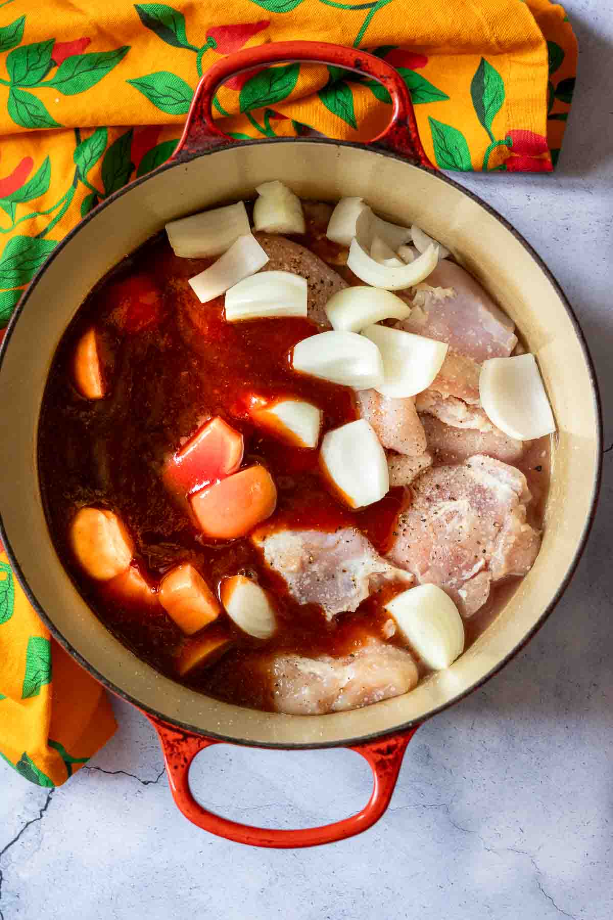 Adding bbq sauce to Dutch oven pulled chicken.
