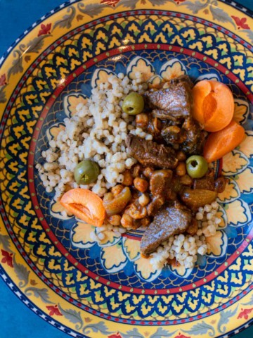Apricot lamb tagine served in a Moroccan platter.