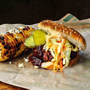 Bobby Flay's Slaw Burgers served with grilled corn.