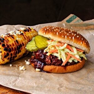 Bobby Flay's slaw burger with bbq sauce and pickles.
