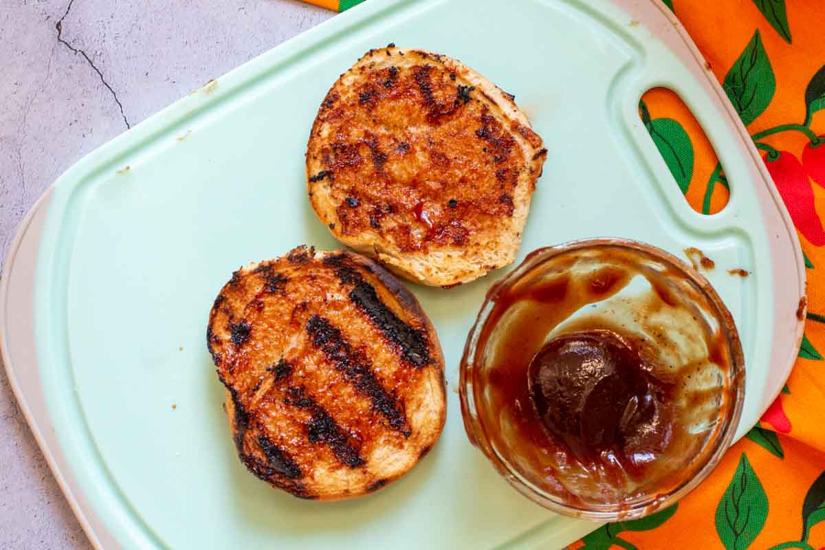Hamburger buns that have been toasted and brushed with bbq sauce.