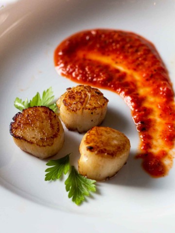 Red pepper coulis with seared scallops.