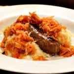 Oven brats served over sauerkraut and mashed potatoes.