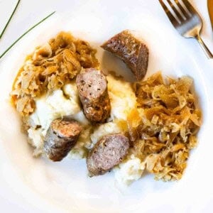 Caramelized kraut and brats served over mashed potatoes.