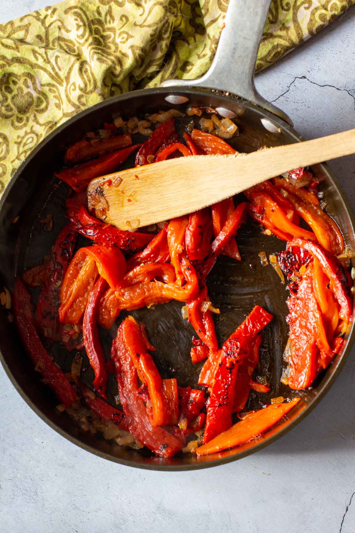 Frying roasted red bell peppers in a fry pan to make red pepper coulis.