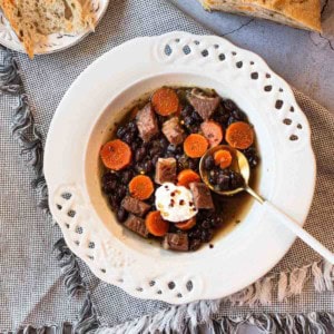 Black bean and ham soup garnished with sour cream.