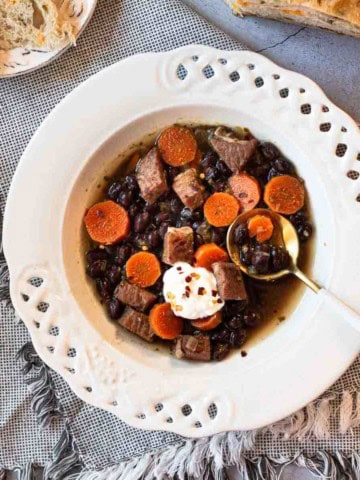 Black bean and ham soup garnished with sour cream.