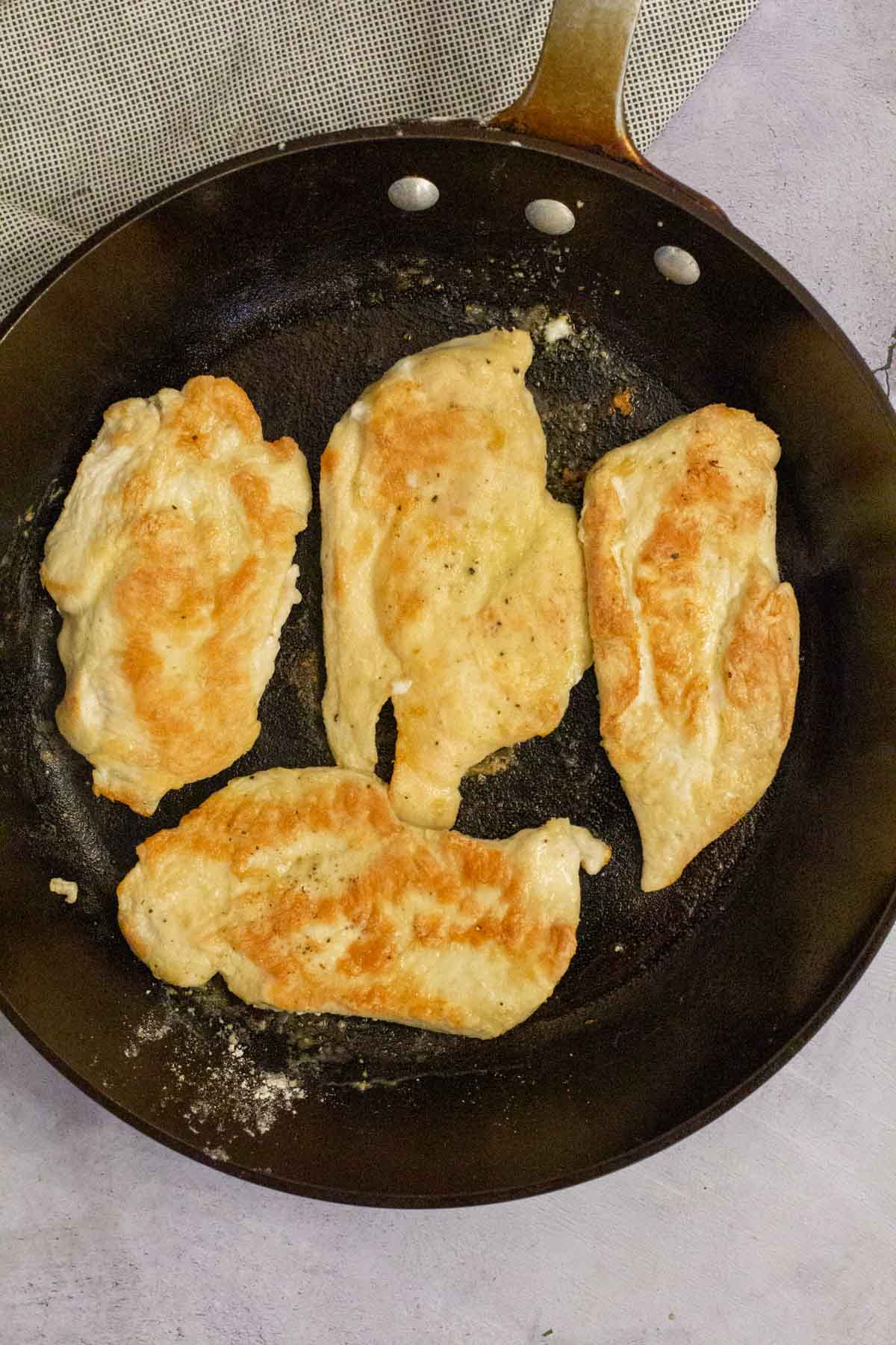 Frying boneless skinless chicken breasts.