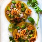 Shrimp tostadas with lime slaw and toppings.