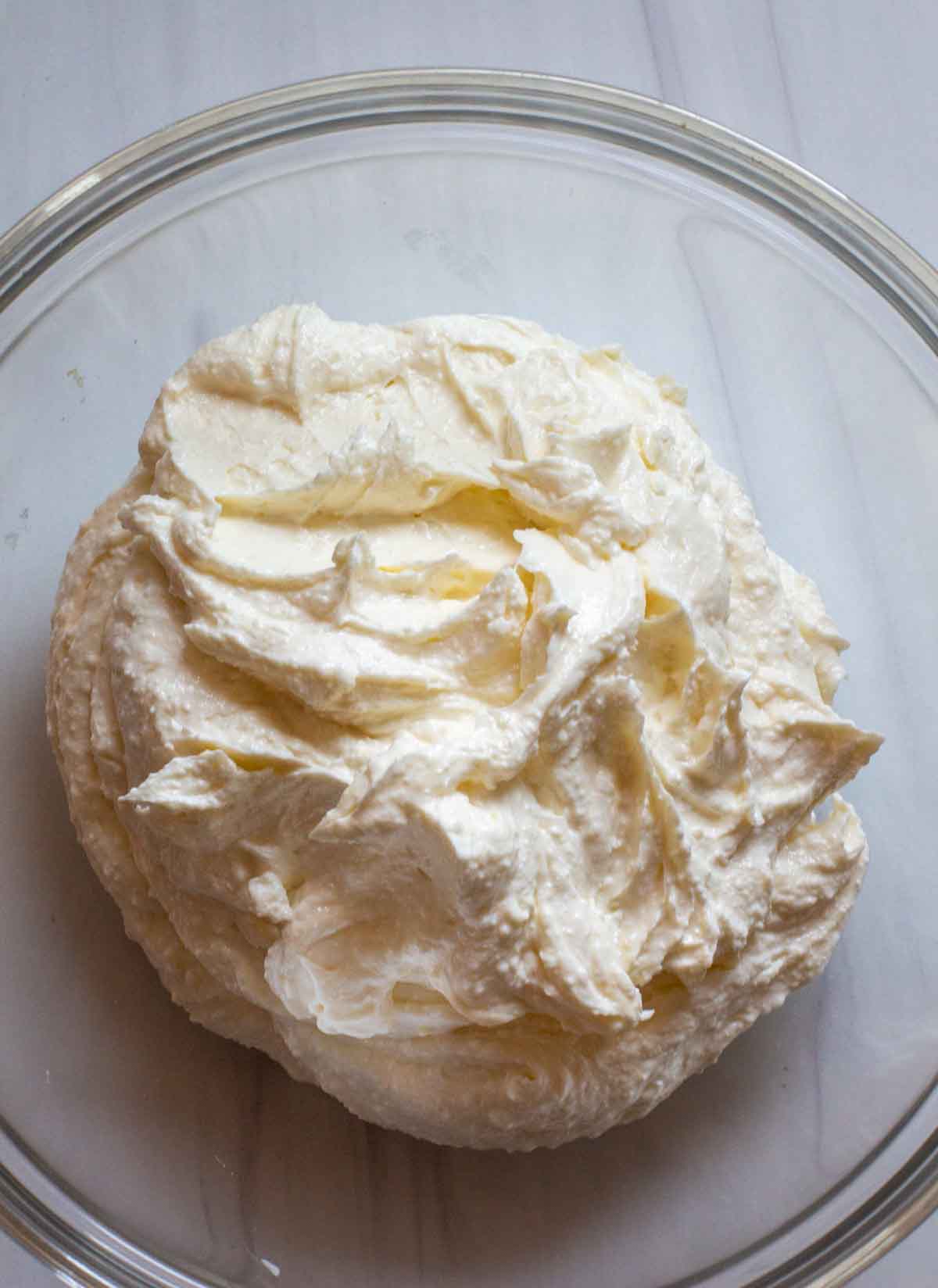 Whipped feta cheese and cream cheese in a bowl.