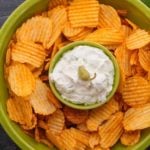 Whipped feta dip with bbq potato chips in a fiestaware green serving bowl.