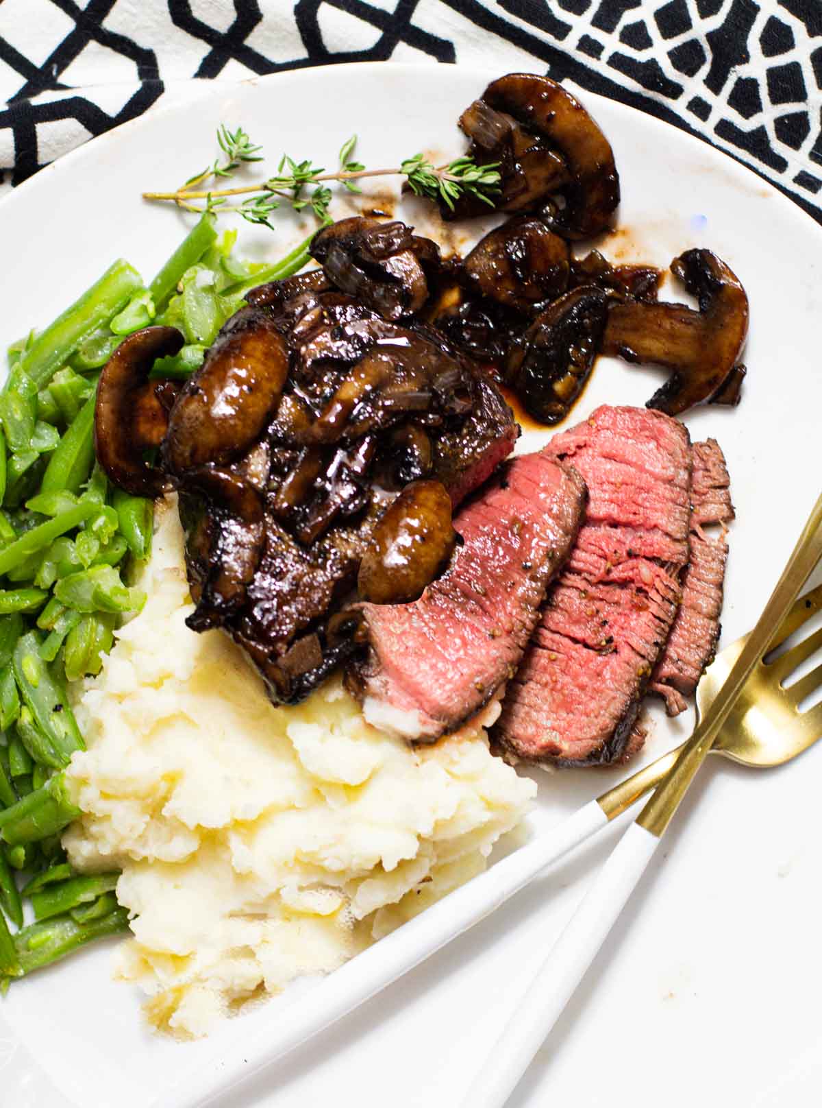 Beef tournados with red wine mushroom sauce served with mashed potatoes and green beans