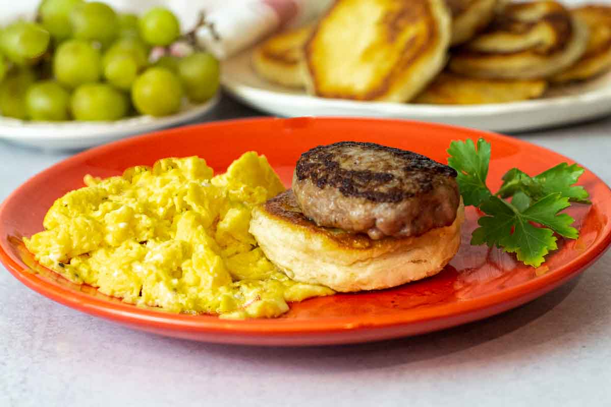 Fried biscuits with sausage and scrambled eggs.