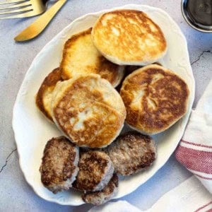 A plate of pan fried biscuits served with sausage patties.