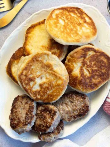 A plate of pan fried biscuits served with sausage patties.