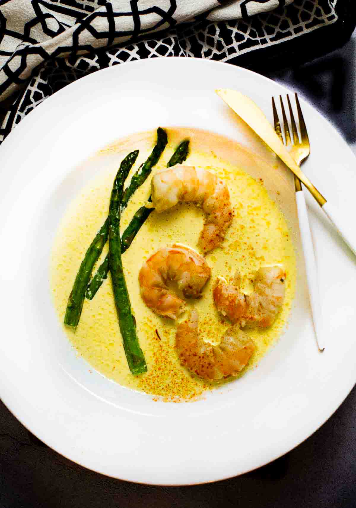 Saffron cream sauce served with shrimp and asparagus.