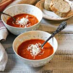 Two bowls of spicy tomato soup made with canned tomatoes.