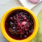 Red onion chutney in a yellow bowl.
