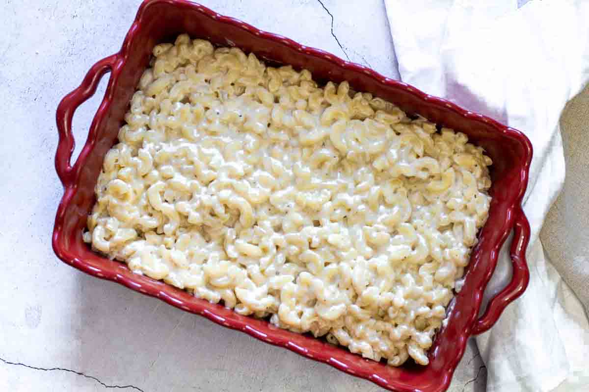 Bechamel mac and cheese in a casserole dish ready to bake.