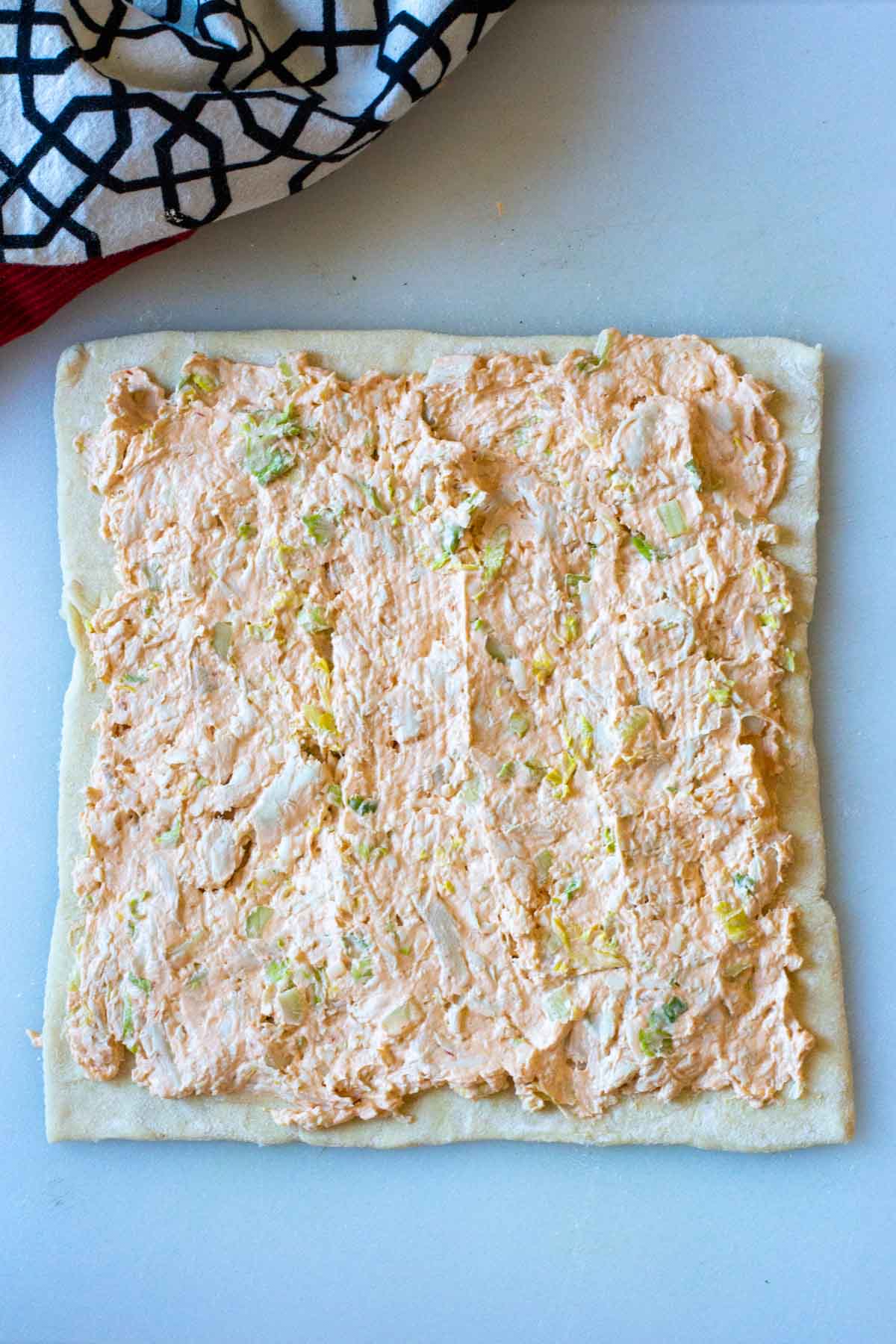 Puff pastry covered with Buffalo Chicken spread.