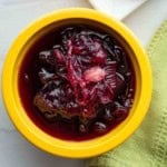 A yellow bowl with homemade red onion chutney.