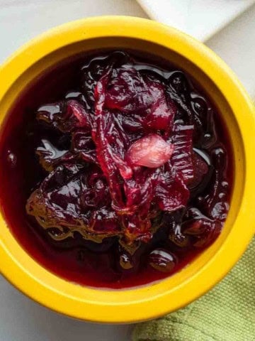 A yellow bowl with homemade red onion chutney.