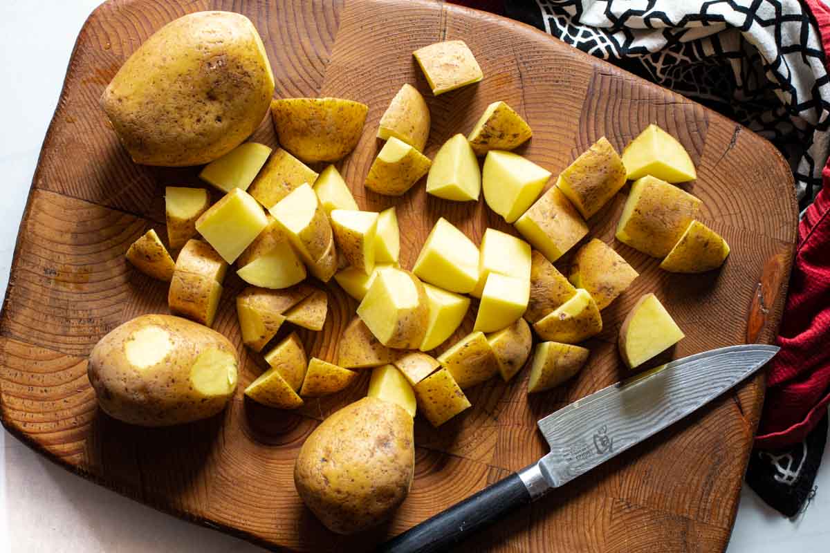 Cubing Yukon Gold potatoes to make Parmesan Crusted Potatoes.