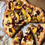 Bacon, jalapeno peach pizza cooked on a pizza stone.