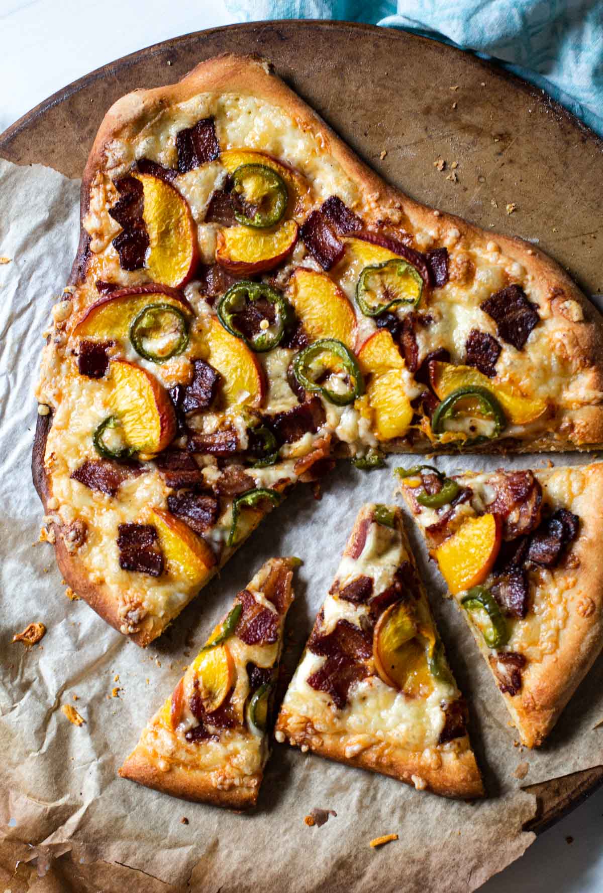 Bacon, jalapeno peach pizza cooked on a pizza stone.