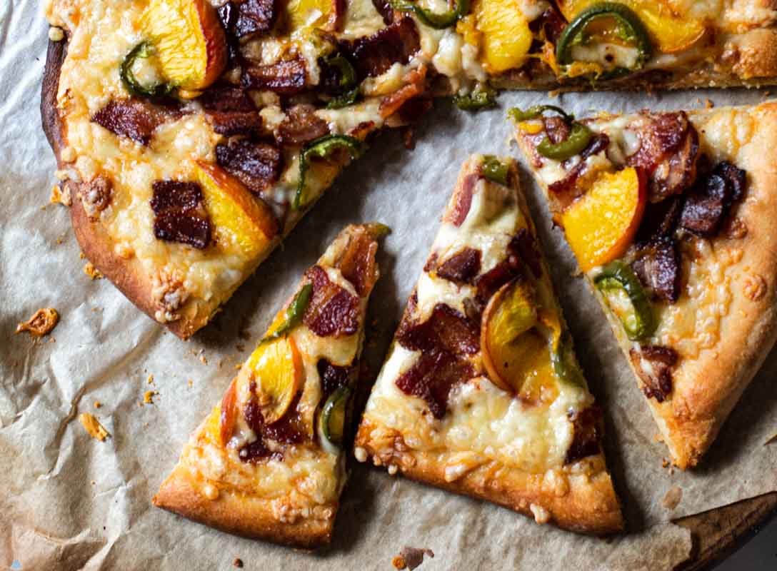 Peach pizza with bacon and jalapeno pepper.