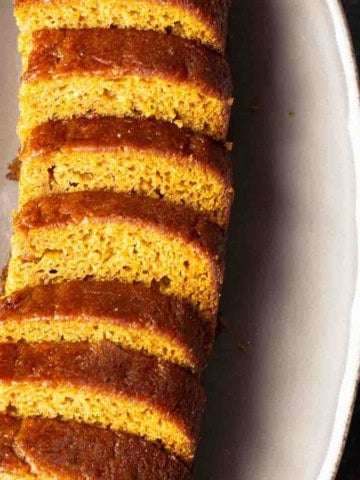 Pumpkin beer bread sliced on a plate.