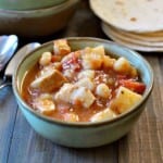 Green chile pork stew served in a green Frankhoma bowl.