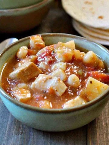 Green chile pork stew served in a green Frankhoma bowl.