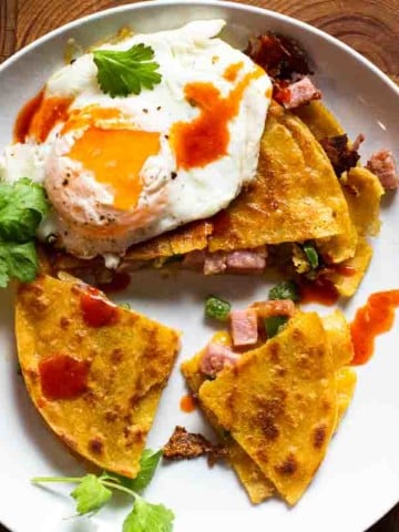 Fried corn tortilla quesadilla topped with a fried egg.