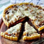 Caramelized Onion Tart on a wooden cutting board.