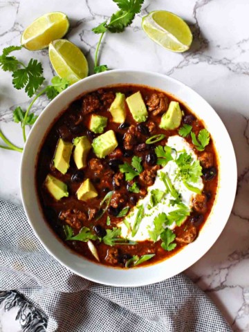 Bison Chile with Black beans topped with chopped avocado and sour cream.