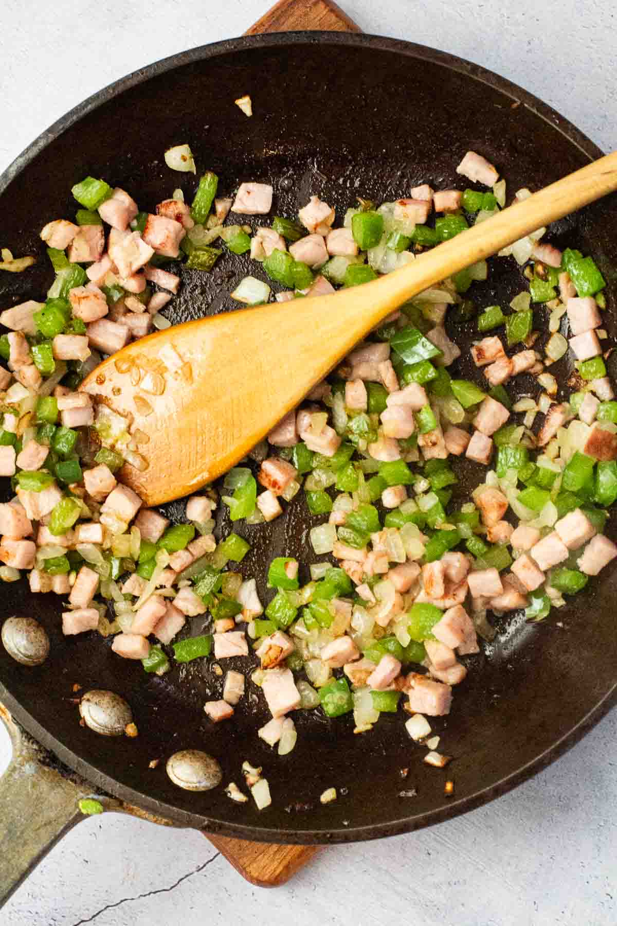 Cooking vegetables and ham to make a Western Omelette.