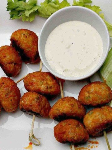 Buffalo chicken meatballs served with celery and blue cheese dressing.