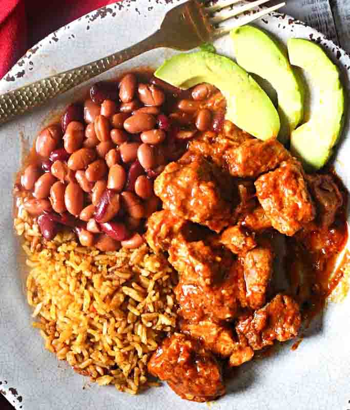 New Mexico Carne Adovada recipe served with beans and rice.